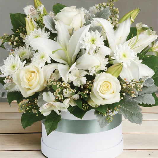 White roses and lilies in the white box