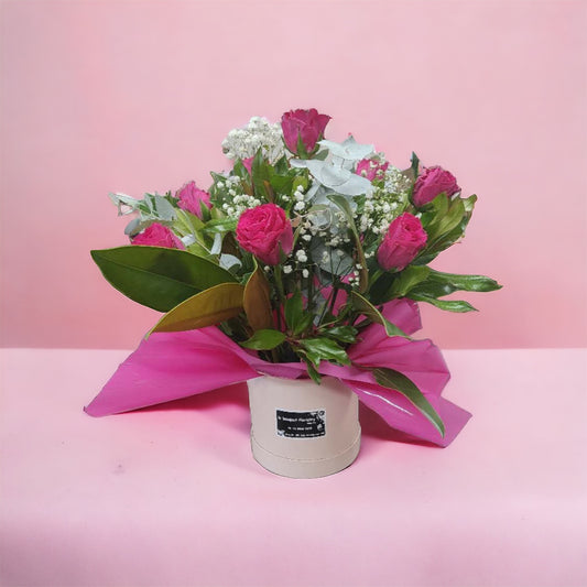 8 hot pink roses in Cuddle Bucket arrangement
