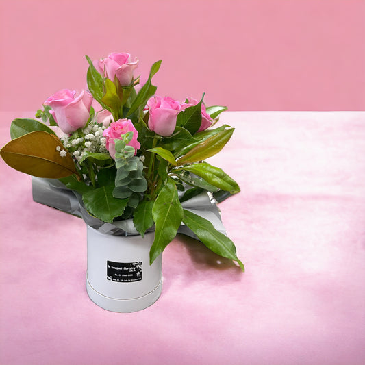 8 pink roses in Cuddle Bucket arrangement